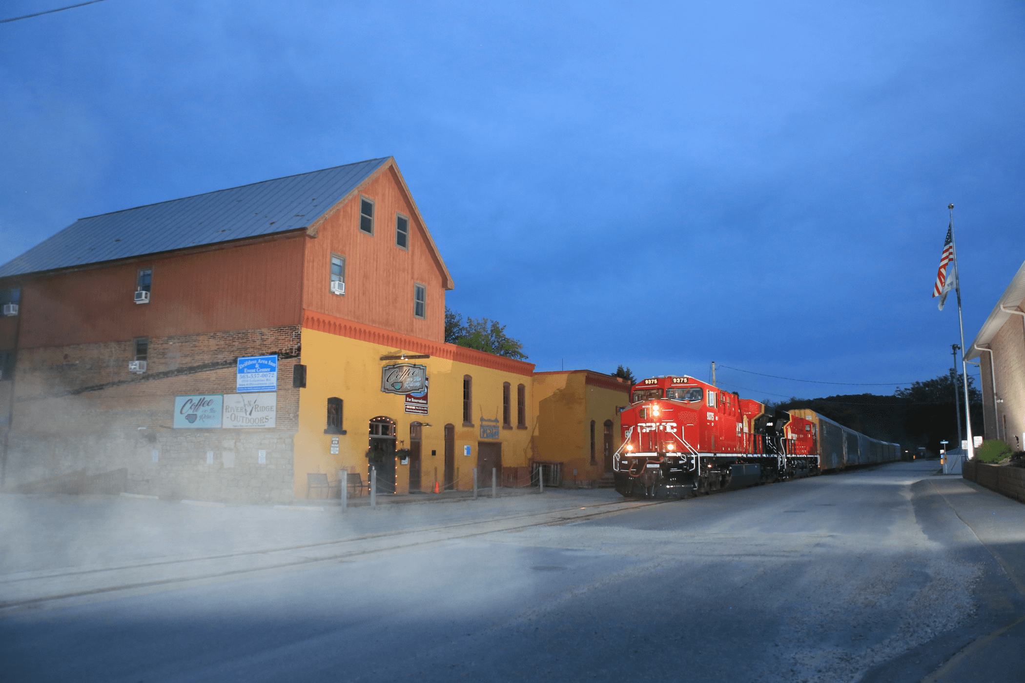 CPKC locomotive traveling through a city